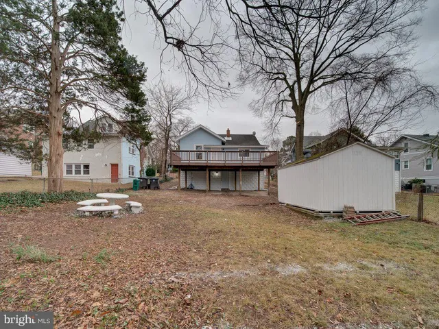 a view of a house with a yard and large tree
