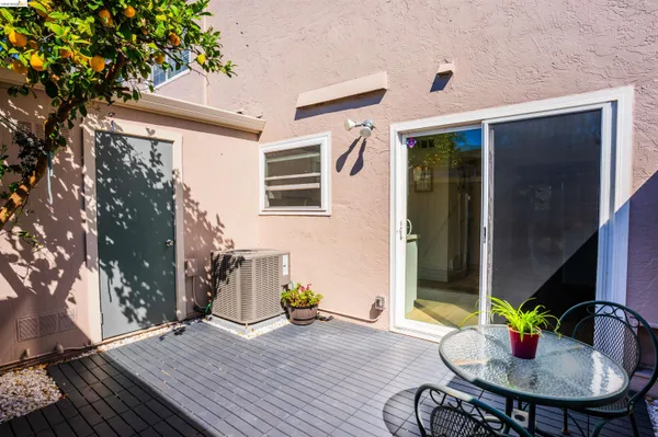 a backyard of a house with table and chairs