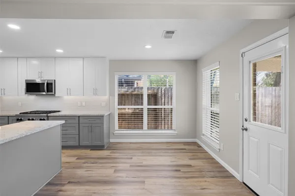 a kitchen with stainless steel appliances granite countertop a stove a sink and a refrigerator