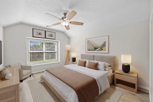 a bedroom with a large bed and a window