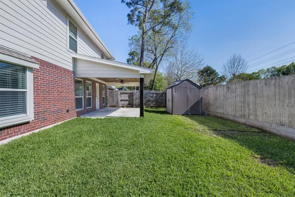 a view of a house with a backyard