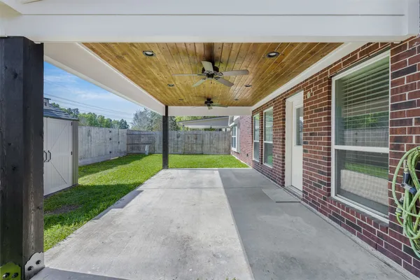 a view of a backyard with wooden fence