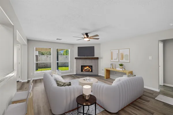 a living room with furniture and a fireplace