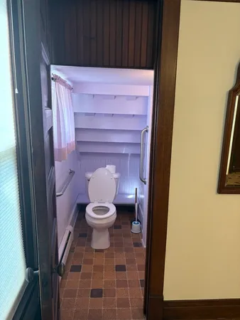 a bathroom with a toilet and a shower