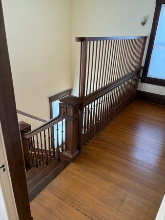 a view of hallway with wooden floor