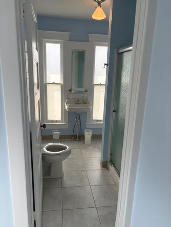 a bathroom with a toilet a sink and a mirror