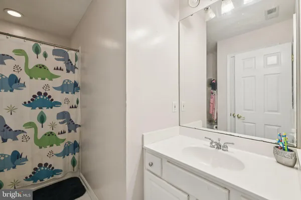 a bathroom with a sink mirror and vanity
