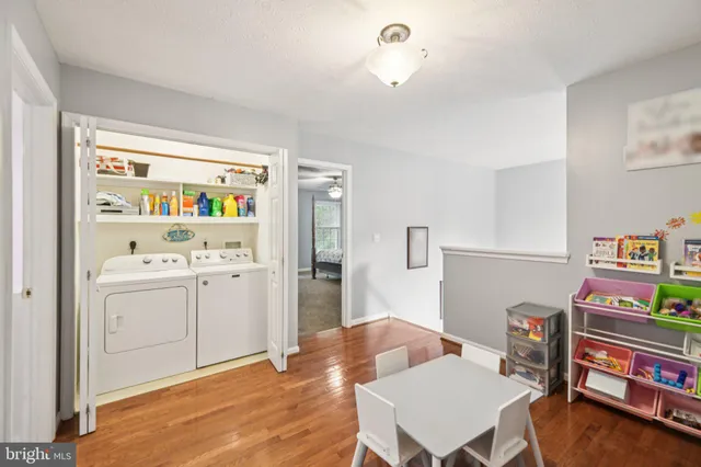 a living room with furniture and baby crib