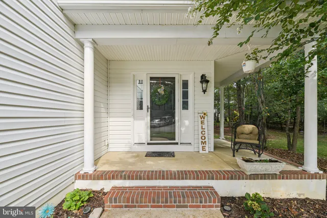 a view of a patio with a table and chairs and potted plants