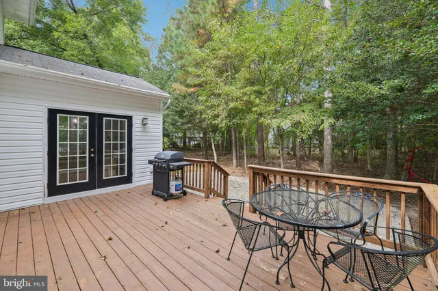 a view of backyard with deck and outdoor seating