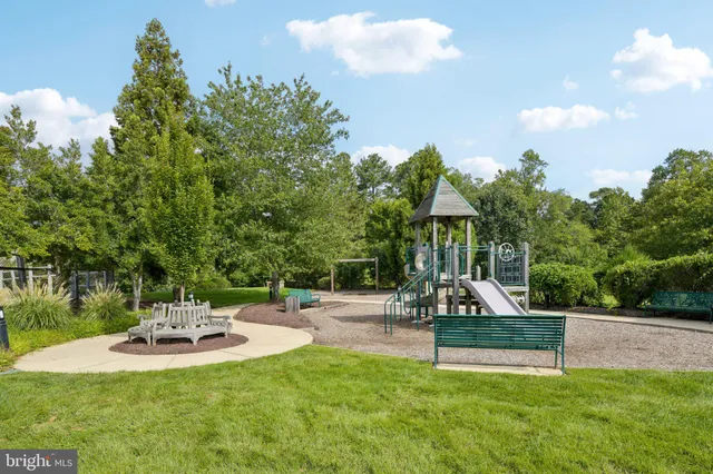 a swimming pool with lots of tress in the background