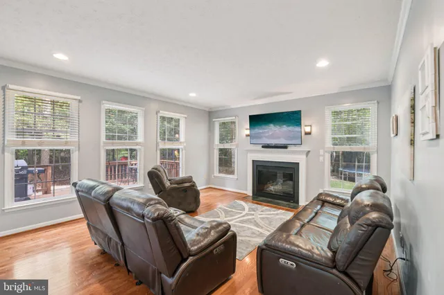 a living room with furniture mirror and a fireplace