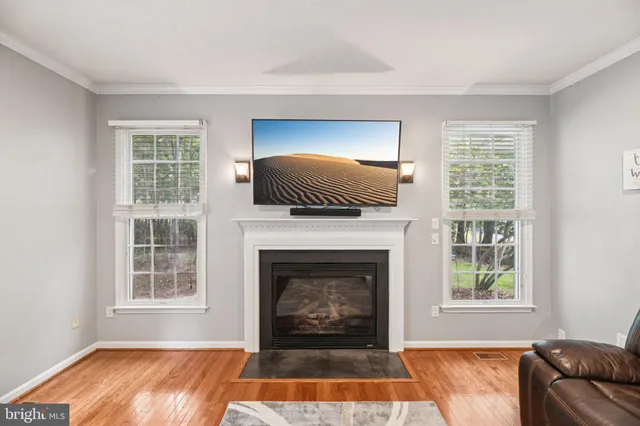 a living room with a fireplace and a window