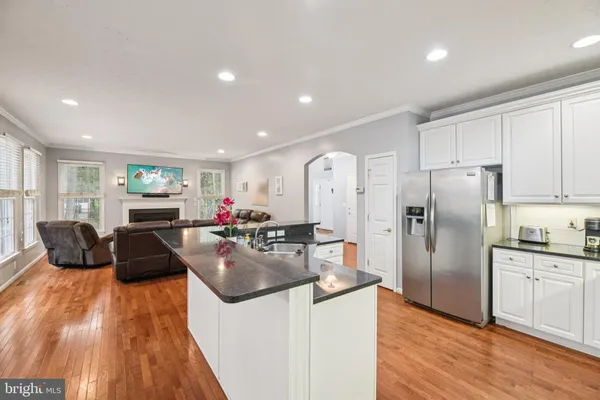 a kitchen that has a lot of cabinets a sink and appliances in it