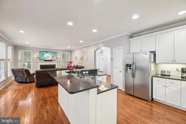 a kitchen that has a lot of cabinets a sink and appliances in it