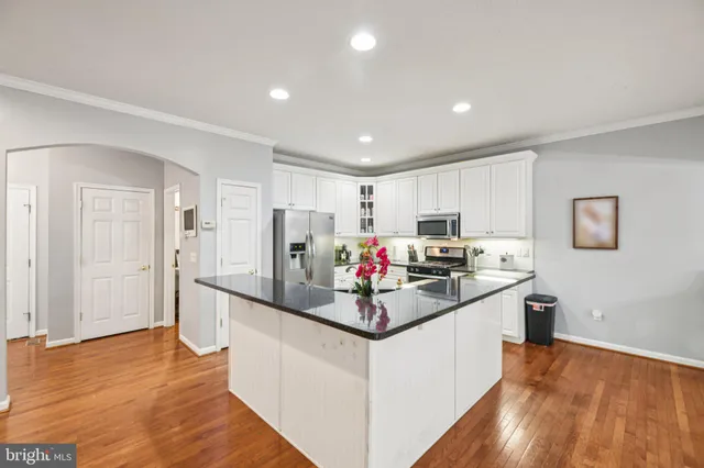 a kitchen that has a lot of cabinets and refrigerator
