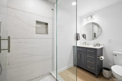 a bathroom with a sink a toilet and mirror