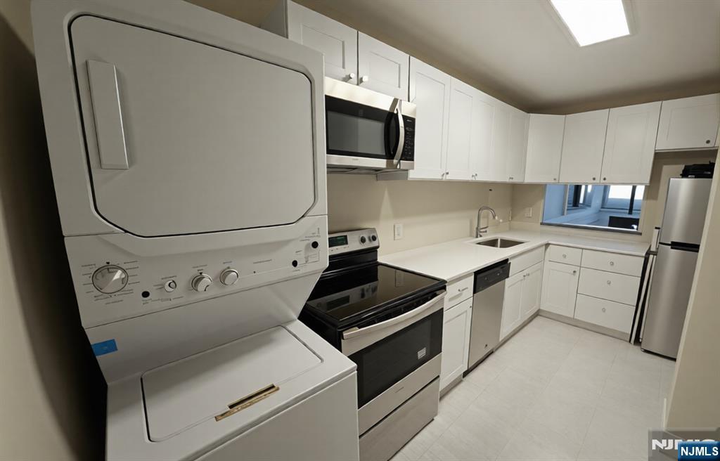 50 Euclid Avenue, Unit 3B Hackensack, NJ 07601 - Photo 6 of 16 a kitchen with cabinets and steel appliances