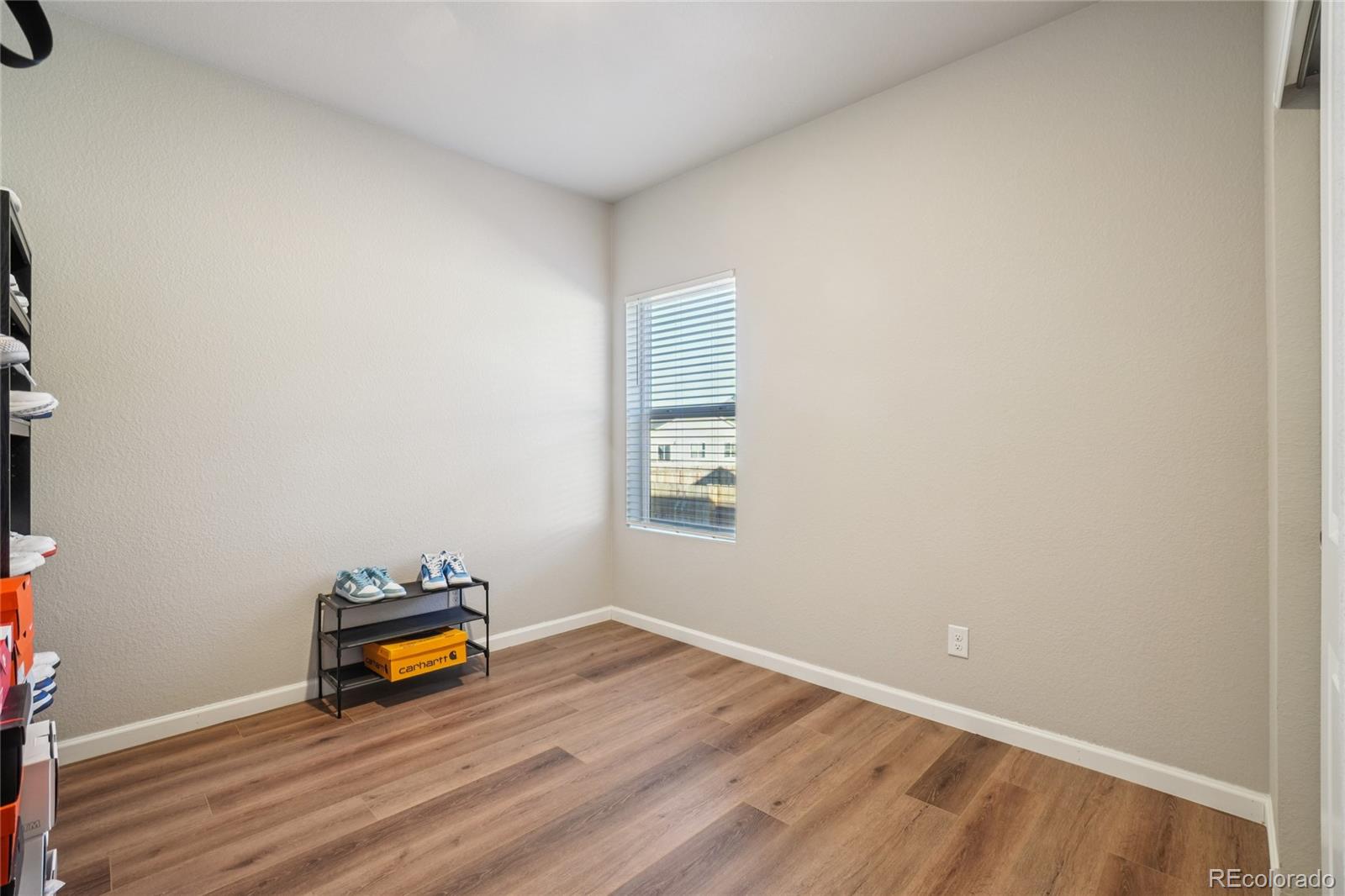 1025 Payton Avenue Fort Lupton, CO 80621 - Photo 12 of 30 an empty room with a window and couch