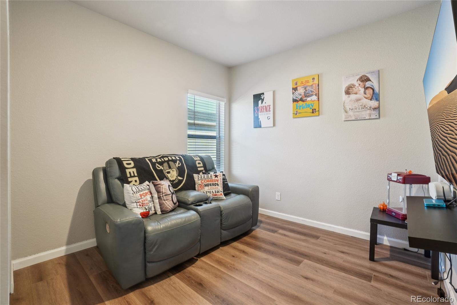 1025 Payton Avenue Fort Lupton, CO 80621 - Photo 14 of 30 a living room with furniture and a wooden floor