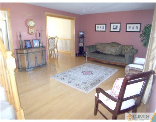 29 West Cliff Road Colonia, NJ 07067 - Photo 2 of 25 a living room with a couch and a table