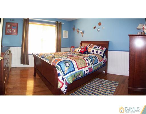 29 West Cliff Road Colonia, NJ 07067 - Photo 16 of 25 a bed sitting in a bedroom next to a window