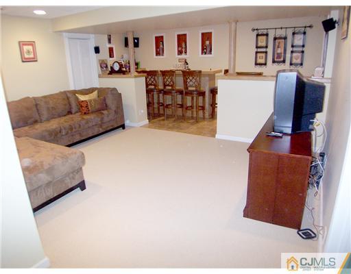 29 West Cliff Road Colonia, NJ 07067 - Photo 20 of 25 a living room with furniture and painting on the wall