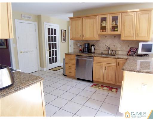 29 West Cliff Road Colonia, NJ 07067 - Photo 7 of 25 a kitchen with stainless steel appliances granite countertop a sink and a cabinets