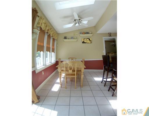 29 West Cliff Road Colonia, NJ 07067 - Photo 8 of 25 a dining room with furniture and a chandelier
