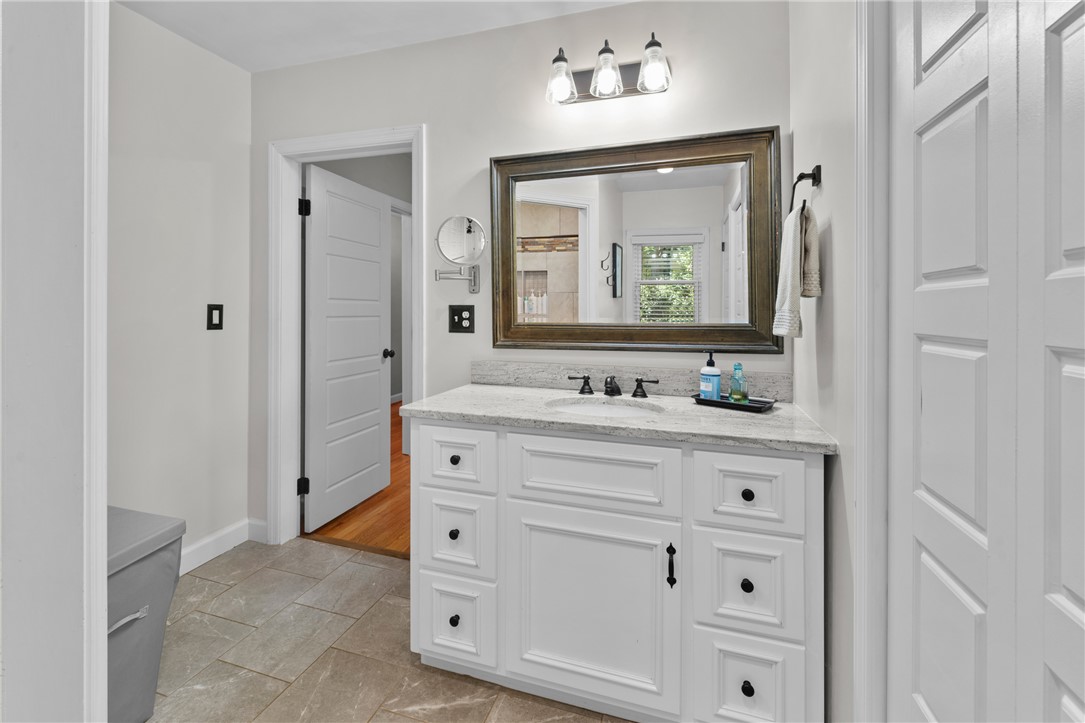 203 Augusta Road Clemson, SC 29631 - Photo 23 of 31 White cabinetry, a polished vanity, and modern fixtures create a serene bathroom oasis.