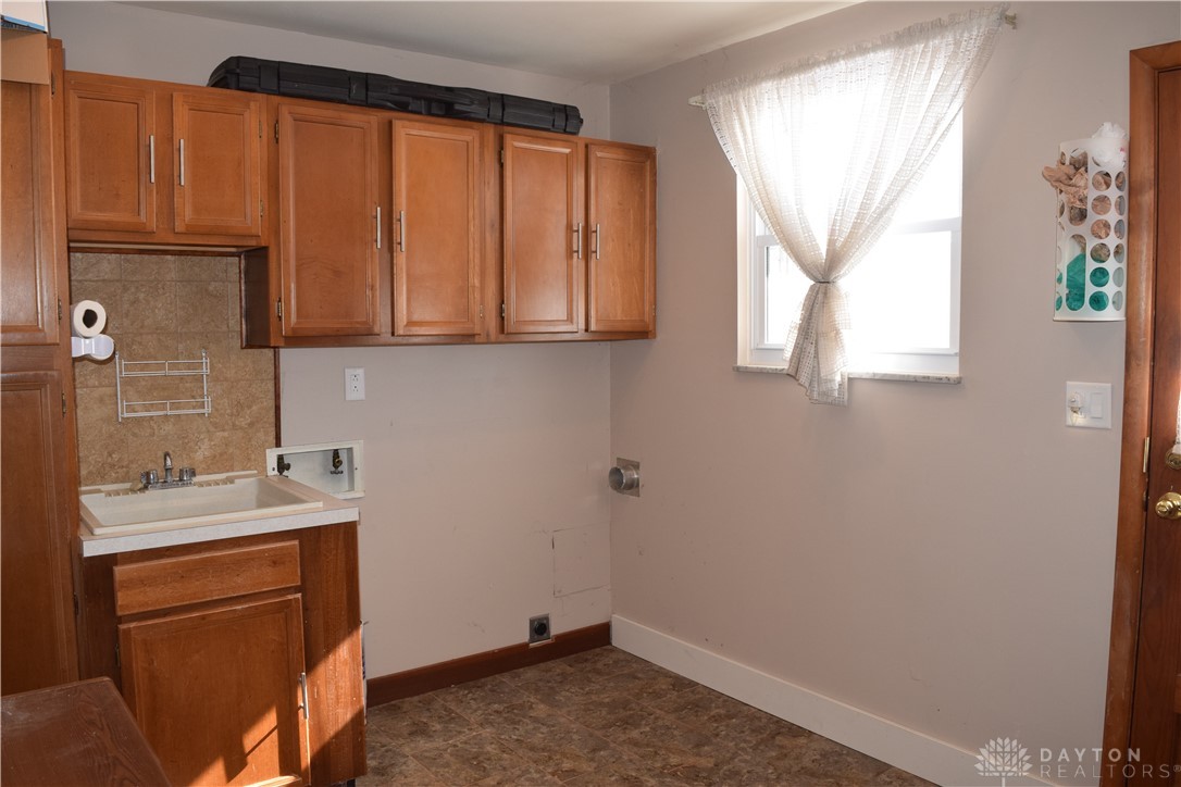 8889 Slagle Road Dayton, OH 45458 - Photo 23 of 29 laundry room is huge and has sink and loads of cabinets