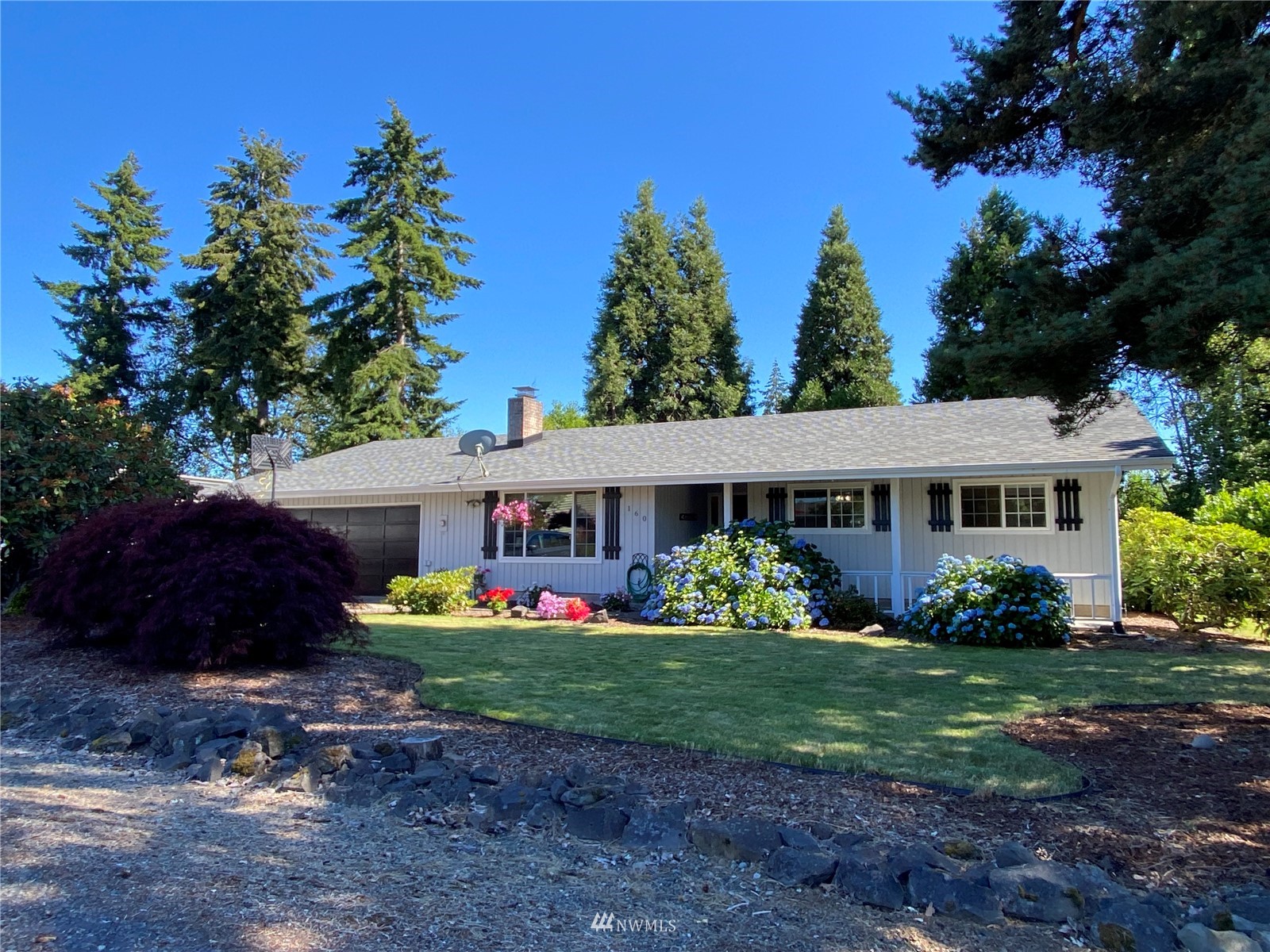 160 Galaxie Road Chehalis, WA 98532 - Photo 1 of 27 a front view of a house with a garden and plants