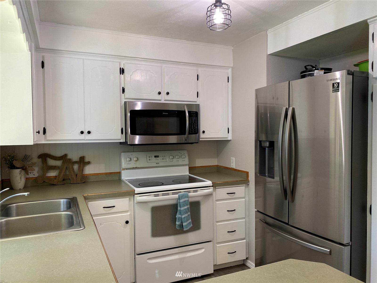 160 Galaxie Road Chehalis, WA 98532 - Photo 12 of 27 a kitchen with white cabinets and stainless steel appliances