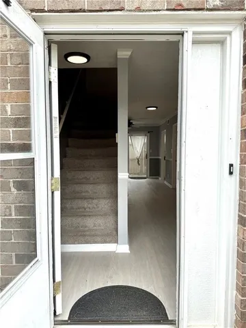a view of a hallway with a dining room and stairs