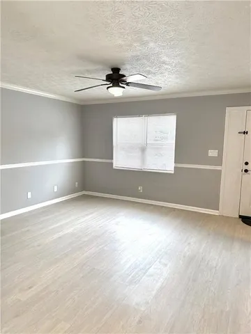 an empty room with windows and entrance