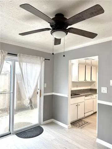 a view of a big room with wooden floor and windows