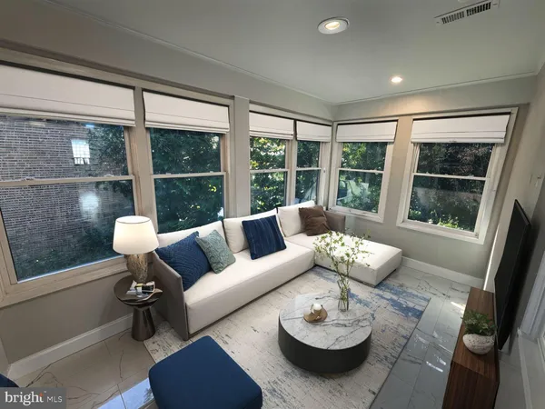 a living room with furniture and a large window