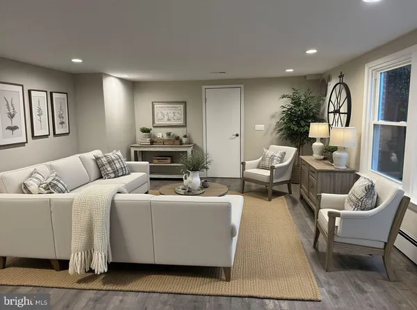 a living room with furniture and wooden floor