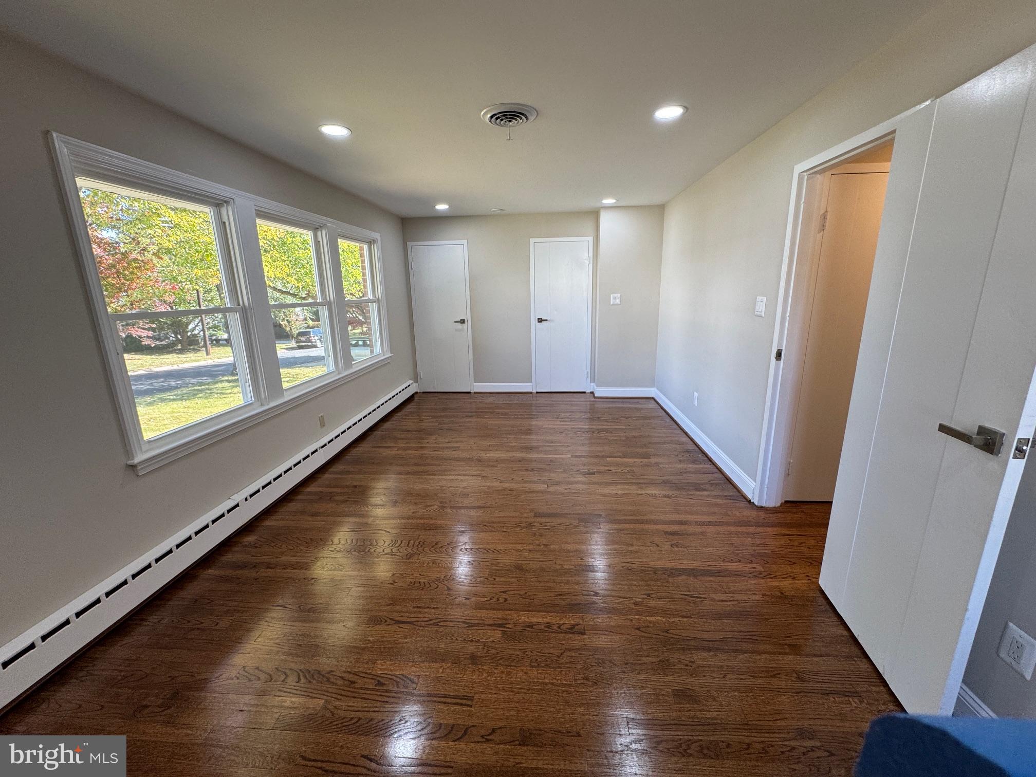 5612 Namakagan Road Bethesda, MD 20816 - Photo 20 of 34 a view of an empty room with wooden floor and a window