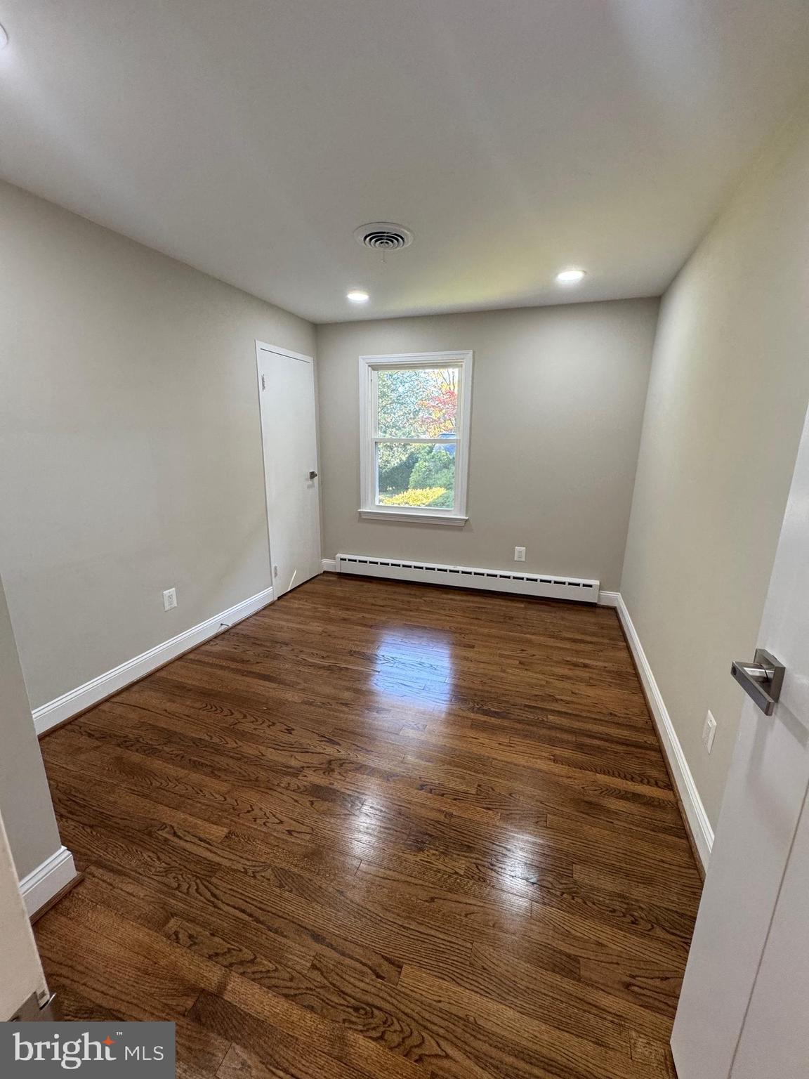 5612 Namakagan Road Bethesda, MD 20816 - Photo 20 of 33 an empty room with wooden floor and windows