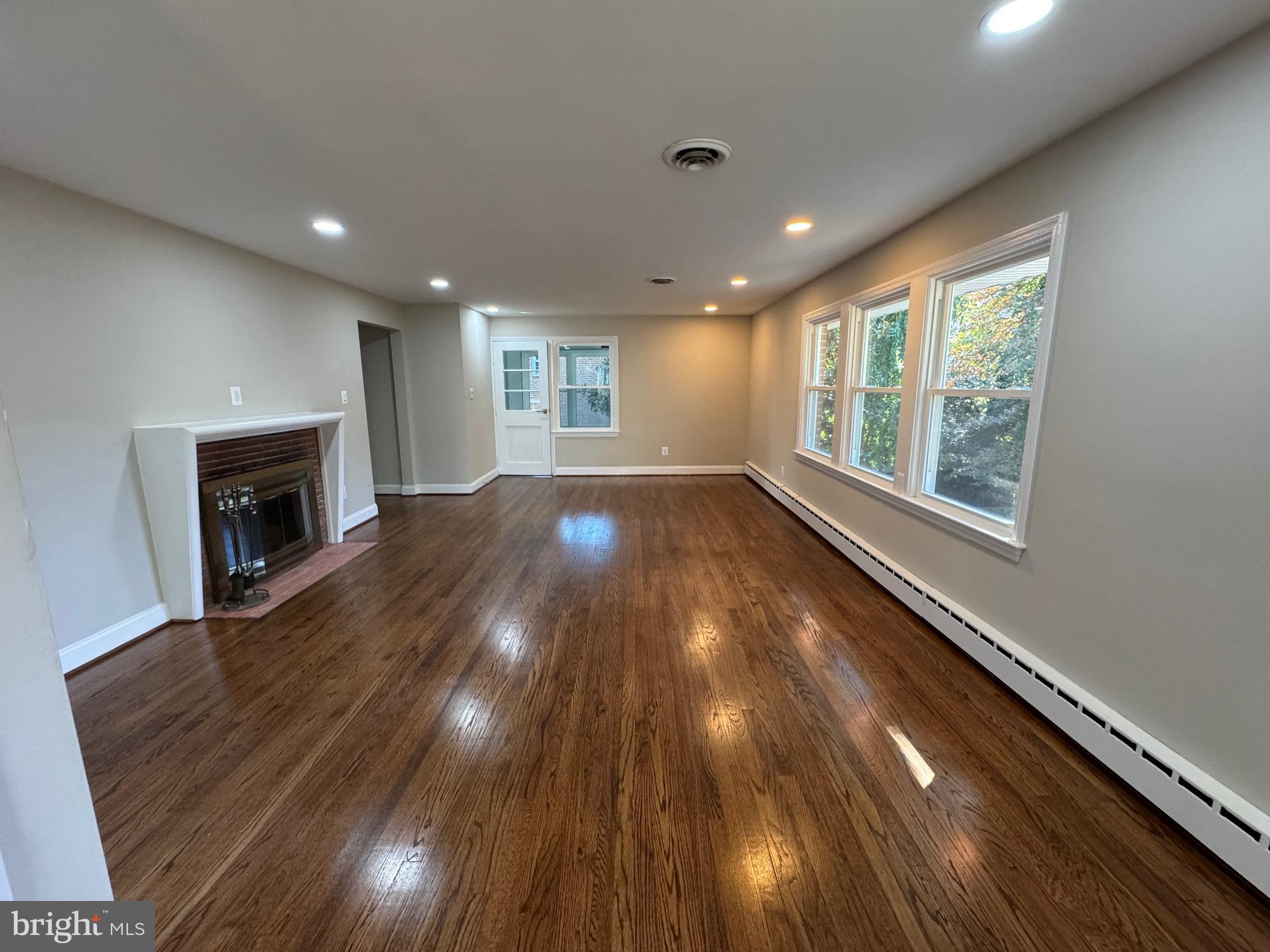 5612 Namakagan Road Bethesda, MD 20816 - Photo 26 of 33 a view of an empty room with wooden floor and a window