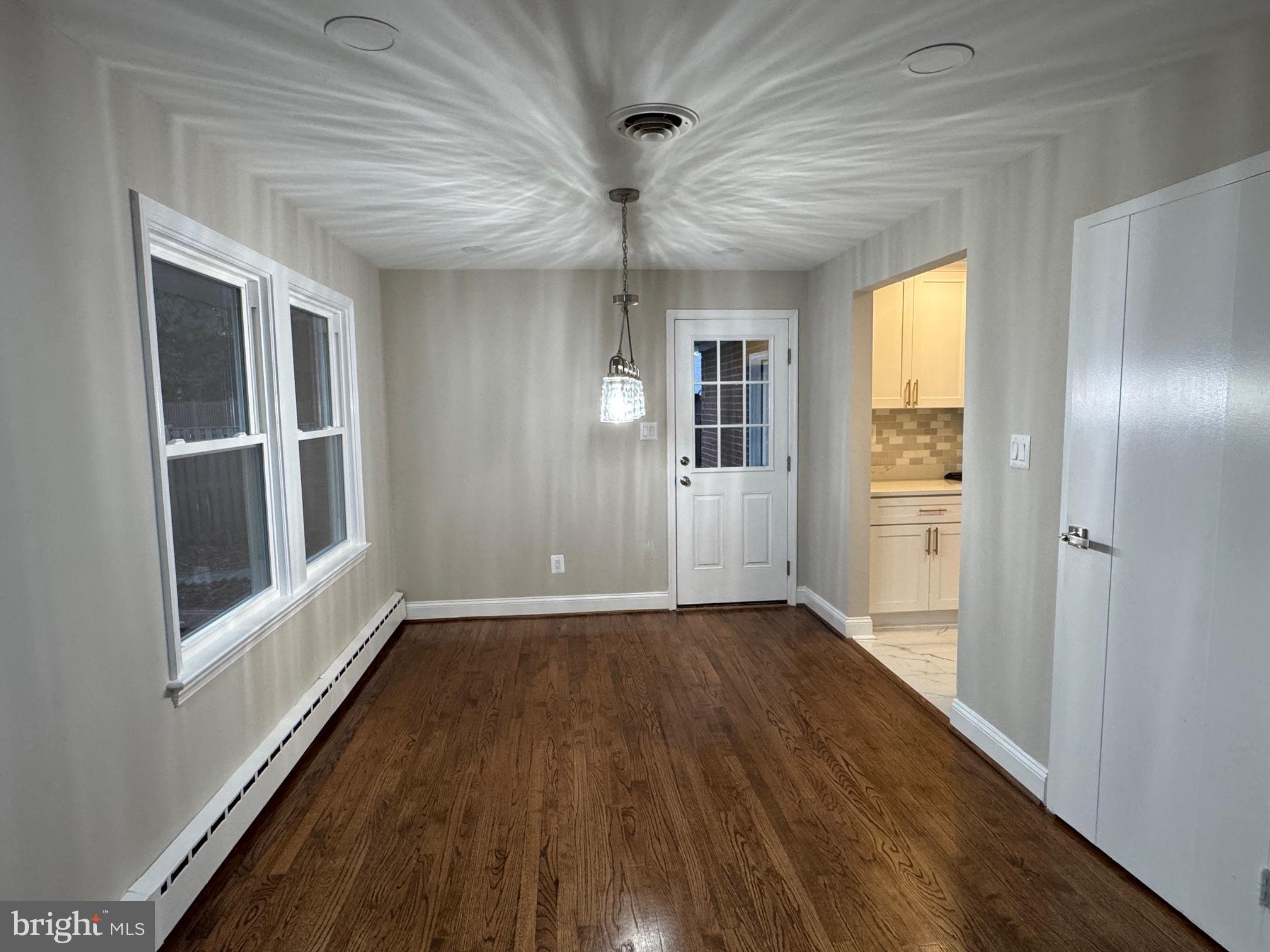 5612 Namakagan Road Bethesda, MD 20816 - Photo 28 of 34 wooden floor in an empty room with a window