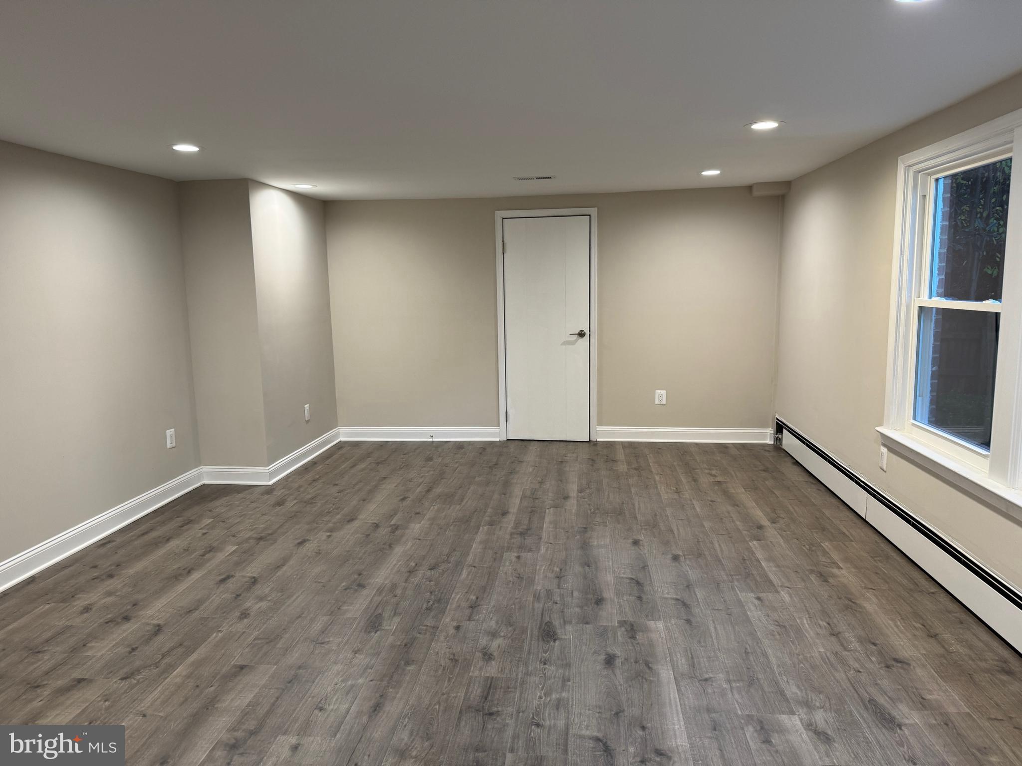 5612 Namakagan Road Bethesda, MD 20816 - Photo 30 of 33 a view of an empty room with wooden floor and window