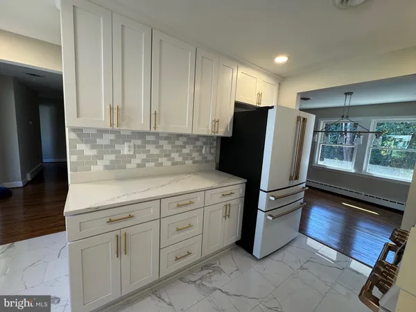 a kitchen with stainless steel appliances a refrigerator sink and cabinets