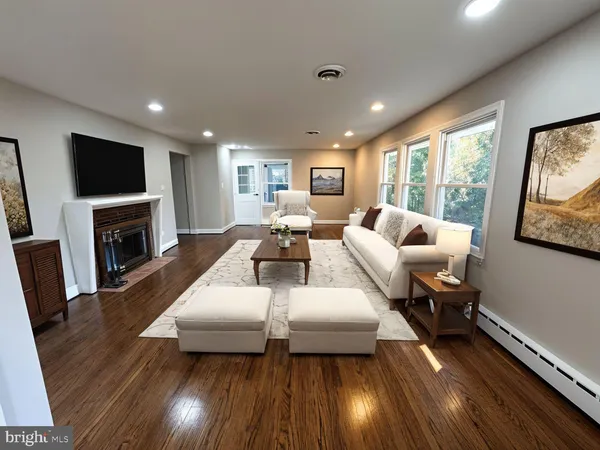 a living room with fireplace furniture and a flat screen tv