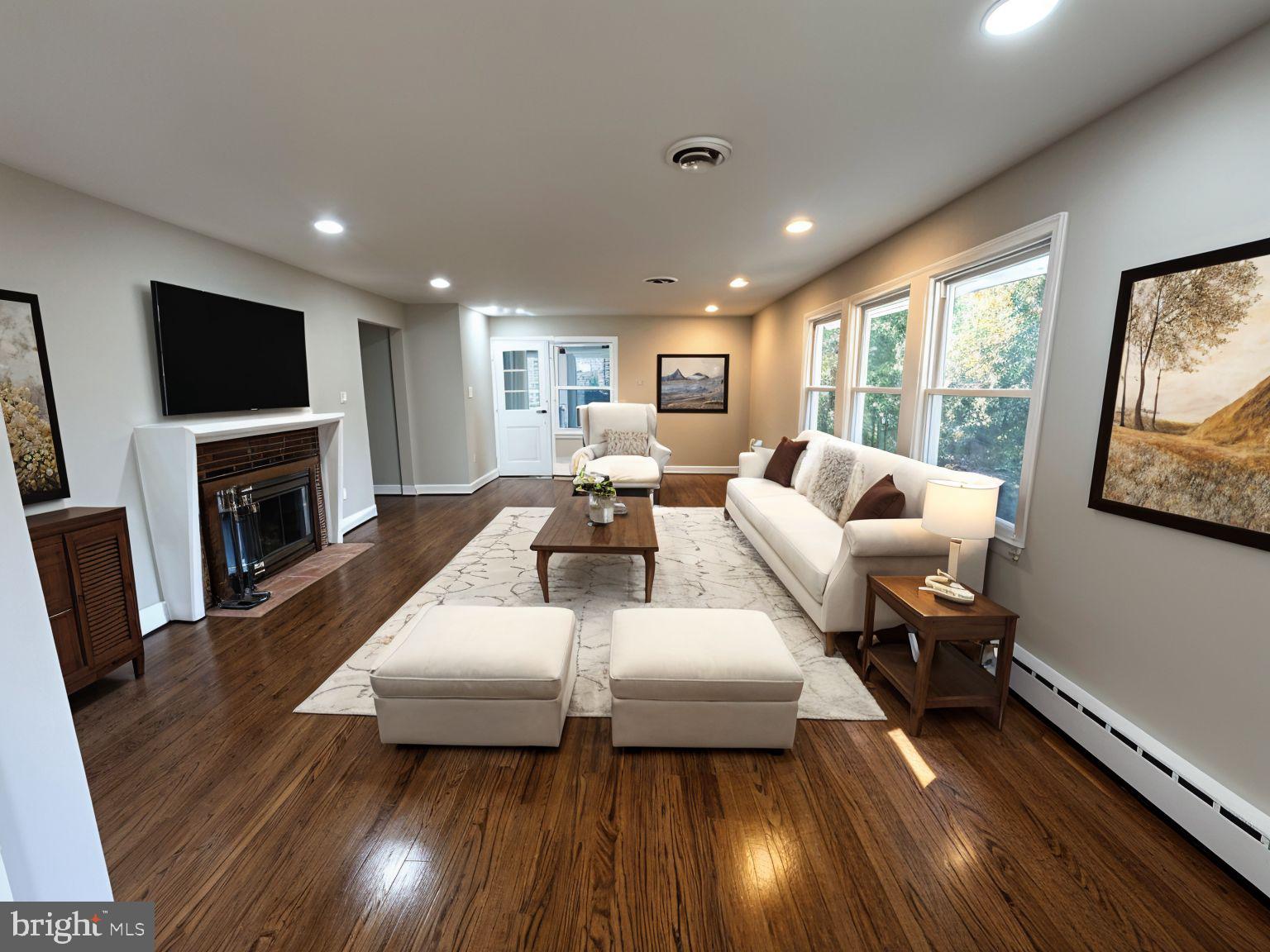 5612 Namakagan Road Bethesda, MD 20816 - Photo 5 of 33 a living room with fireplace furniture and a flat screen tv
