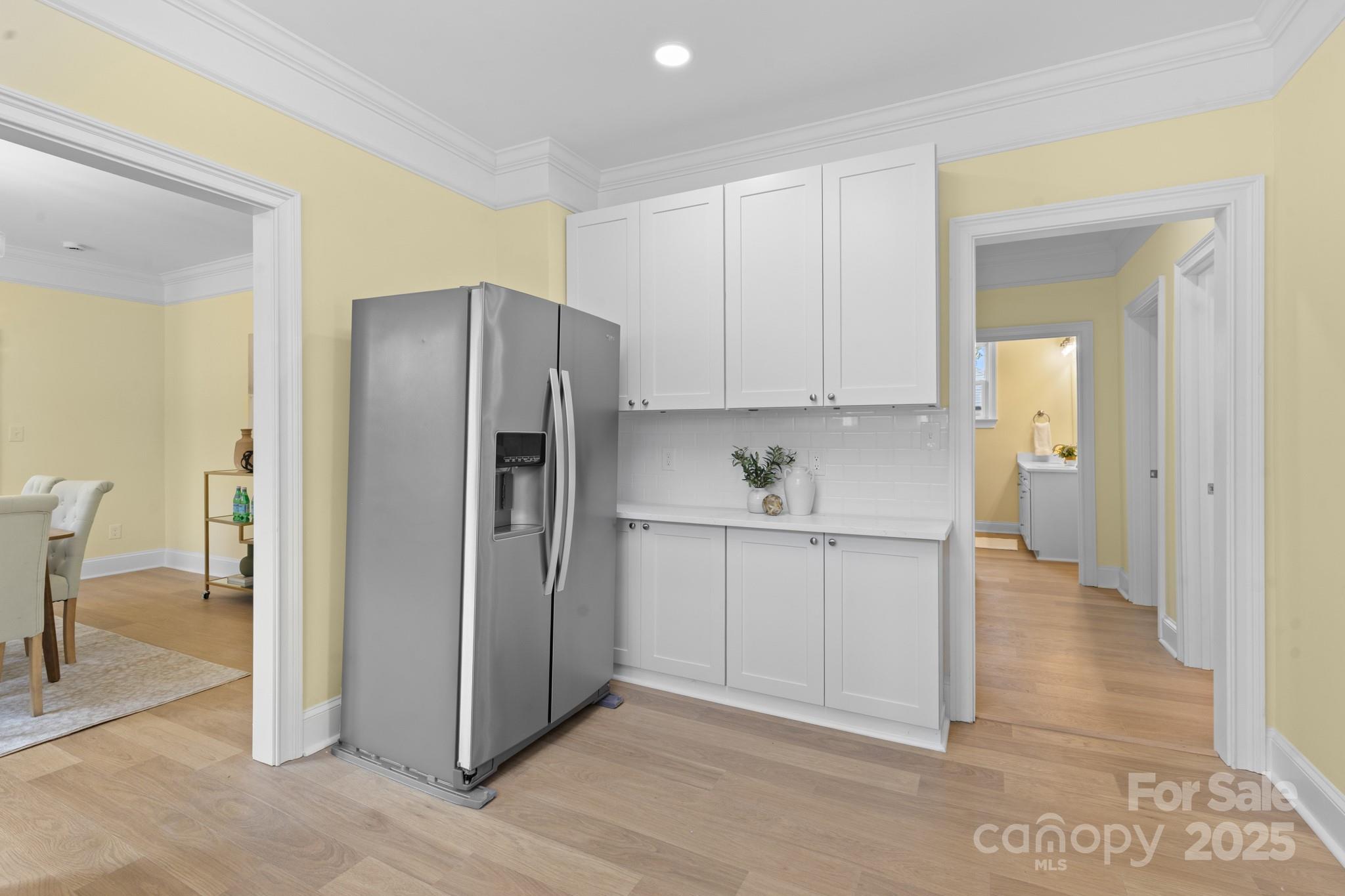 304 West Gay Street Lancaster, SC 29720 - Photo 12 of 28 a kitchen with white cabinets and stainless steel appliances