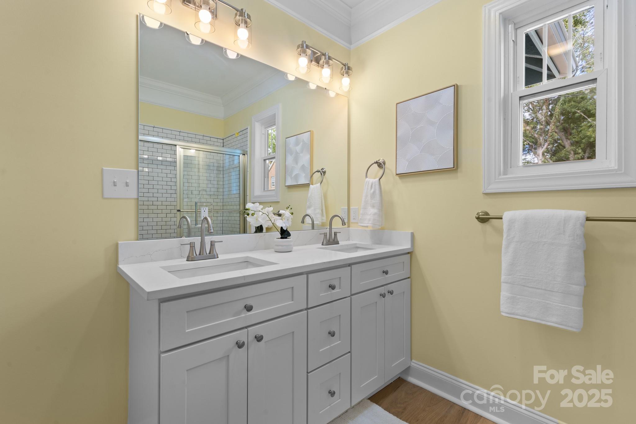 304 West Gay Street Lancaster, SC 29720 - Photo 20 of 28 a bathroom with a double vanity sink and a mirror