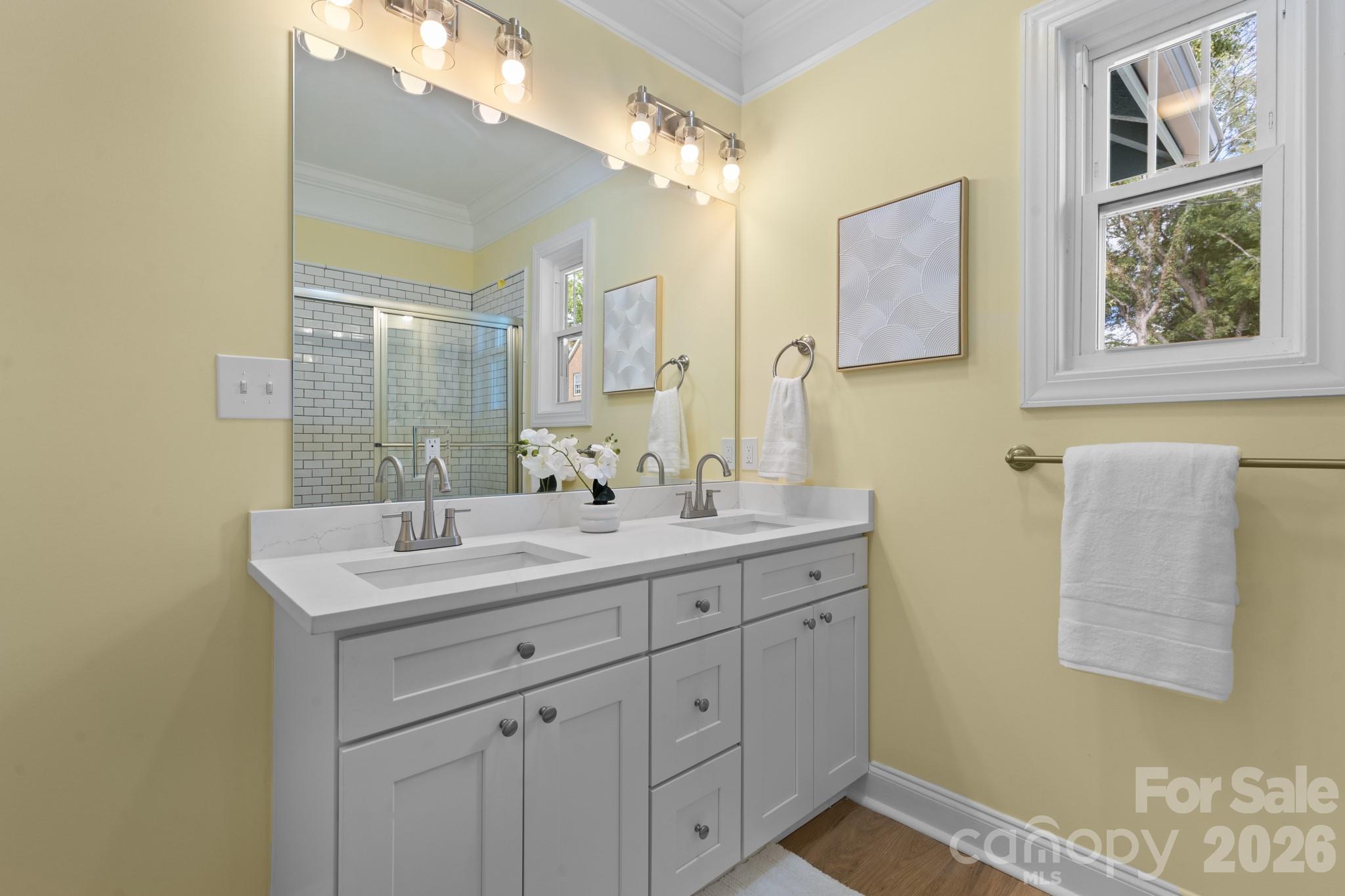 304 West Gay Street Lancaster, SC 29720 - Photo 20 of 28 a bathroom with a double vanity sink and a mirror