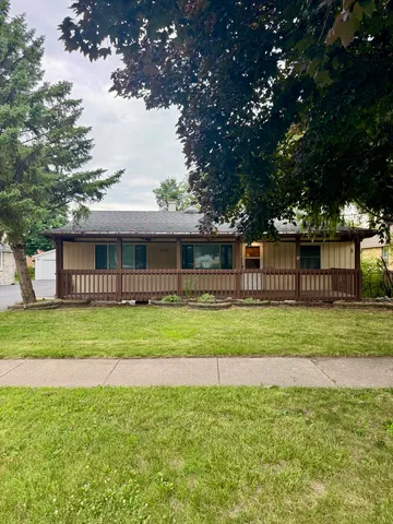 a front view of a house with a garden
